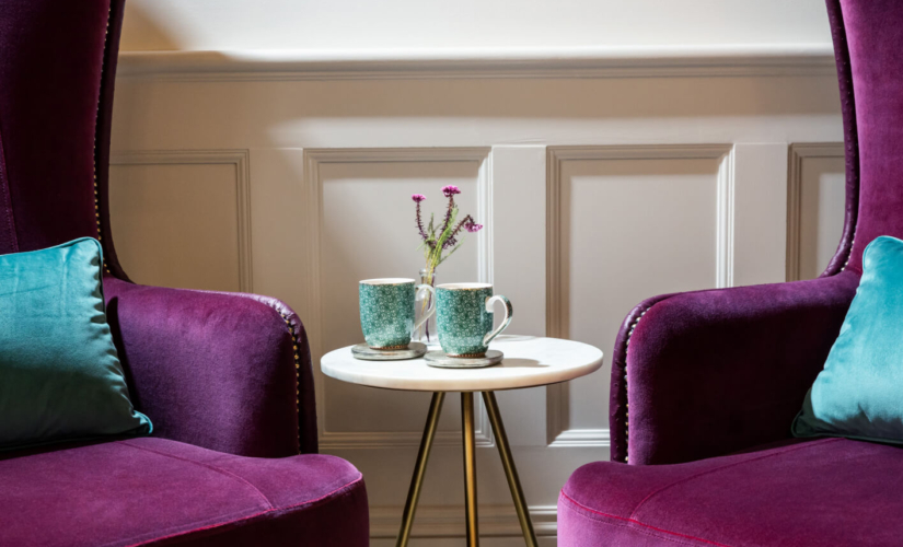 Two mugs and two sofas in the Evewell Clinic waiting room