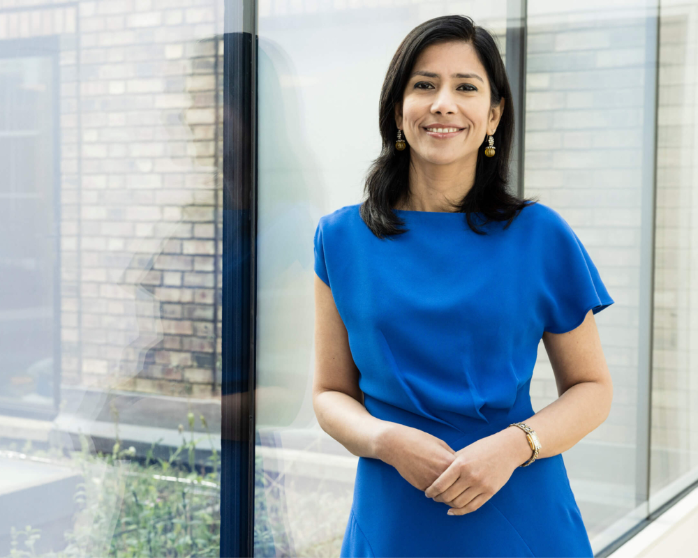 Dr Jyoti Taneja standing by a glass window at the Evewell Clinic