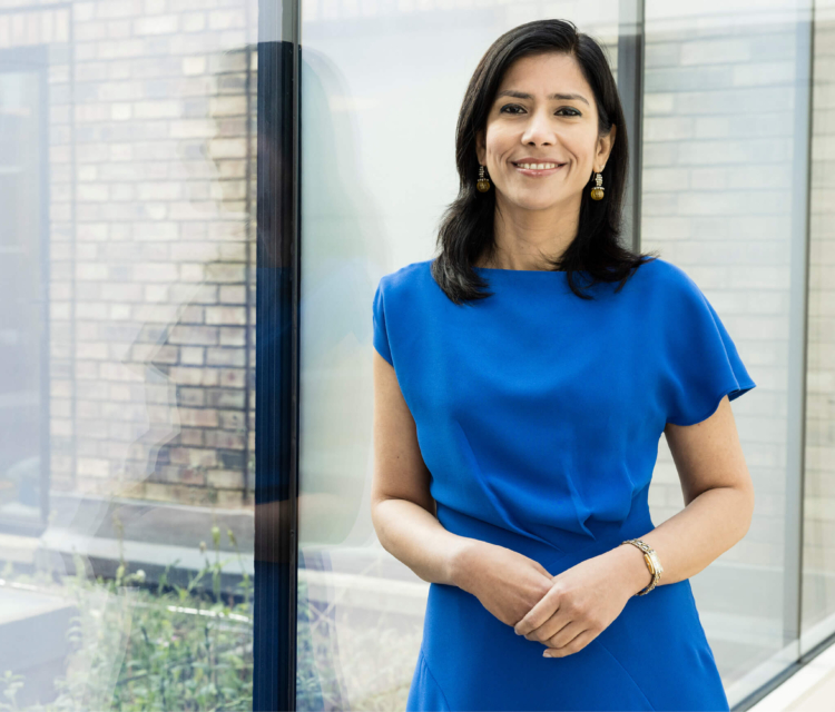 Dr Jyoti Taneja standing by a glass window at the Evewell Clinic