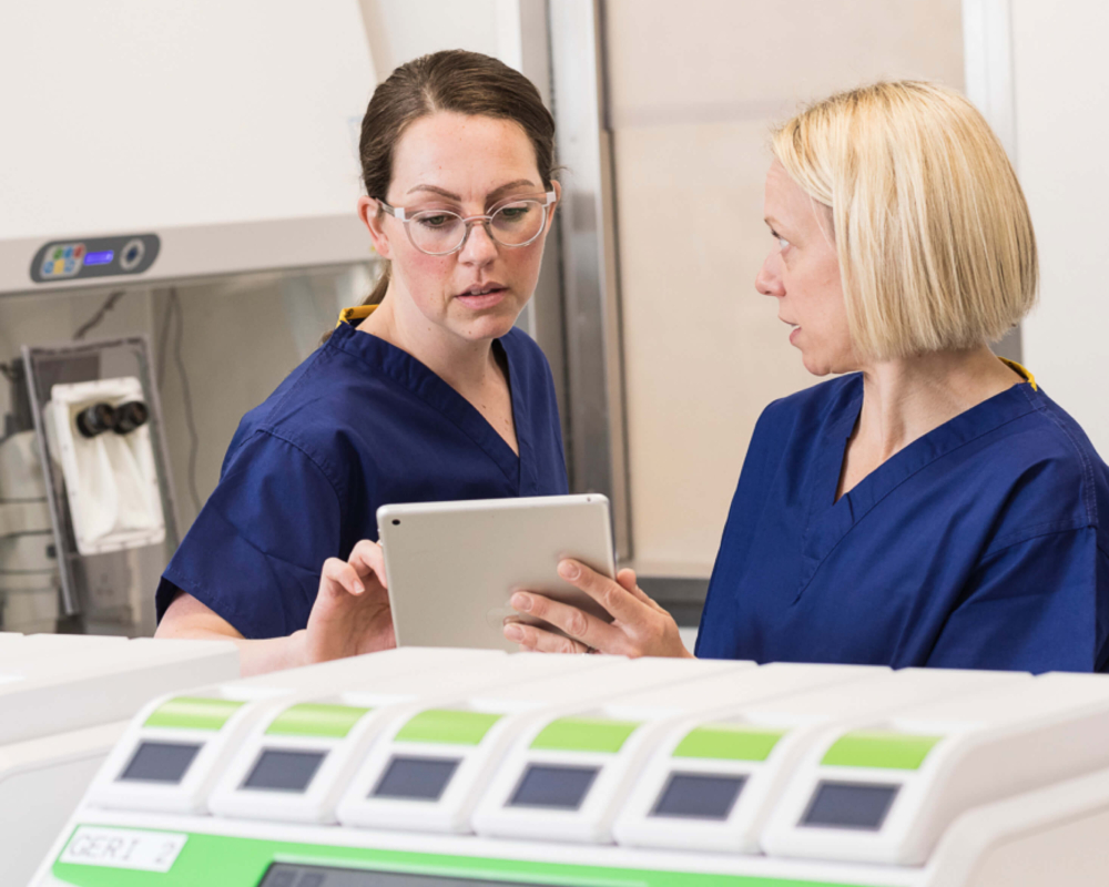 Two embryologists in the laboratory discussing fertility treatments for a patient