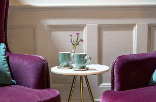 Two mugs and two sofas inside the Evewell Clinic