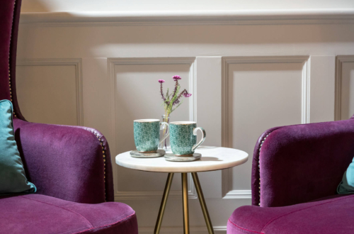 Two mugs and two sofas inside the Evewell Clinic