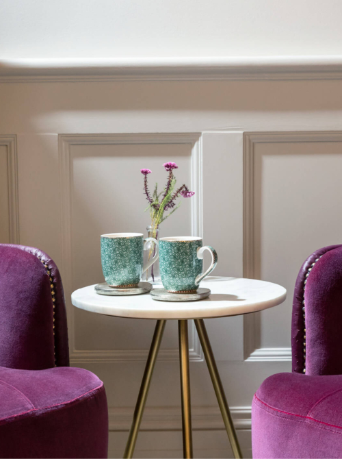 Two mugs and two sofas inside the Evewell Clinic