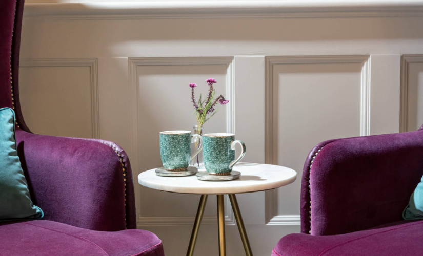 Two mugs and two sofas inside the Evewell Clinic