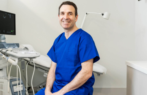 Colin Davis fertility consultant sitting in scrubs in the Evewell laboratory