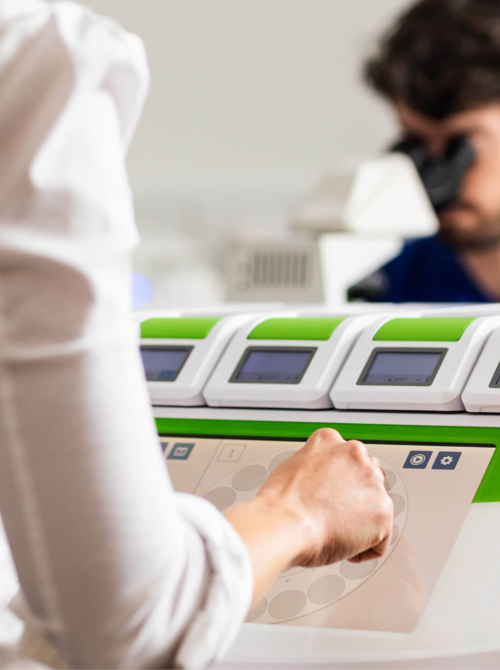 Embryologists looking at embryo samples for ICSI in the Evewell laboratory