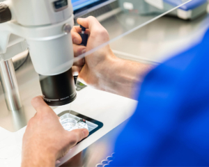 Picture of equipment in a fertility laboratory with an embryologist doing PGT A testing