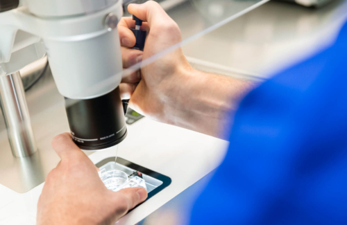 Picture of equipment in a fertility laboratory with an embryologist doing PGT A testing