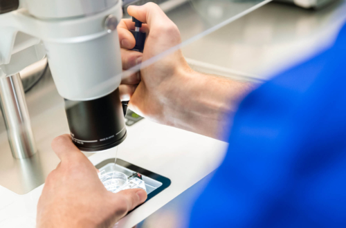 Picture of equipment in a fertility laboratory with an embryologist doing PGT A testing