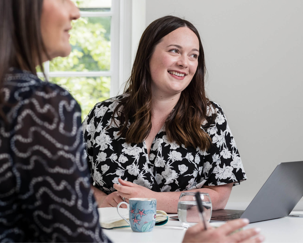 Two consultants sitting at a table discussing fertility questions