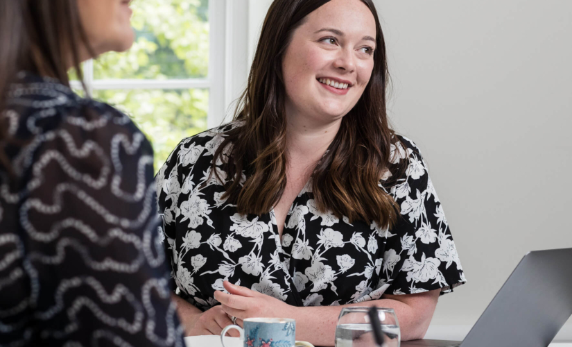 Two consultants sitting at a table discussing fertility questions