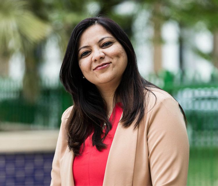 Image of a consultant sitting outside smiling into the camera