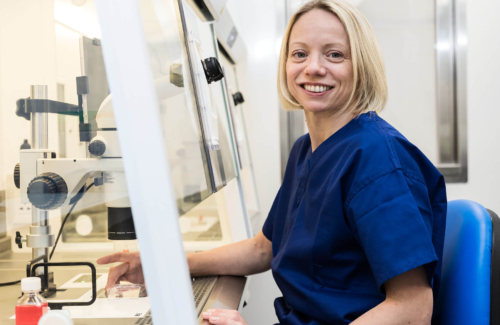 Embryologist sitting in her lab looking at fertility samples and embryo freezing