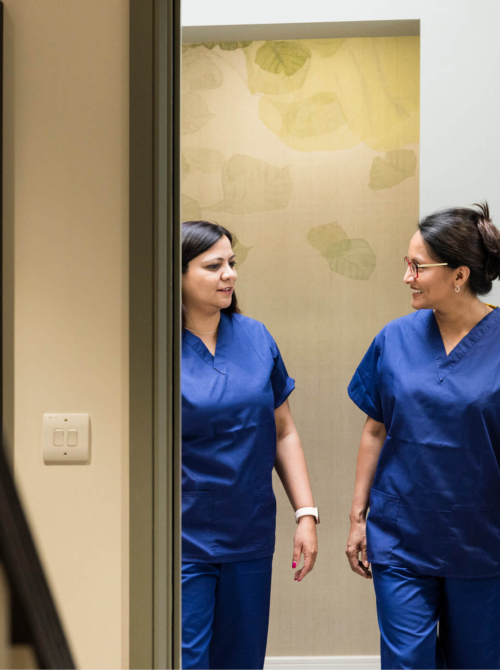 Two fertility nurses chatting and walking around the Evewell Clinic