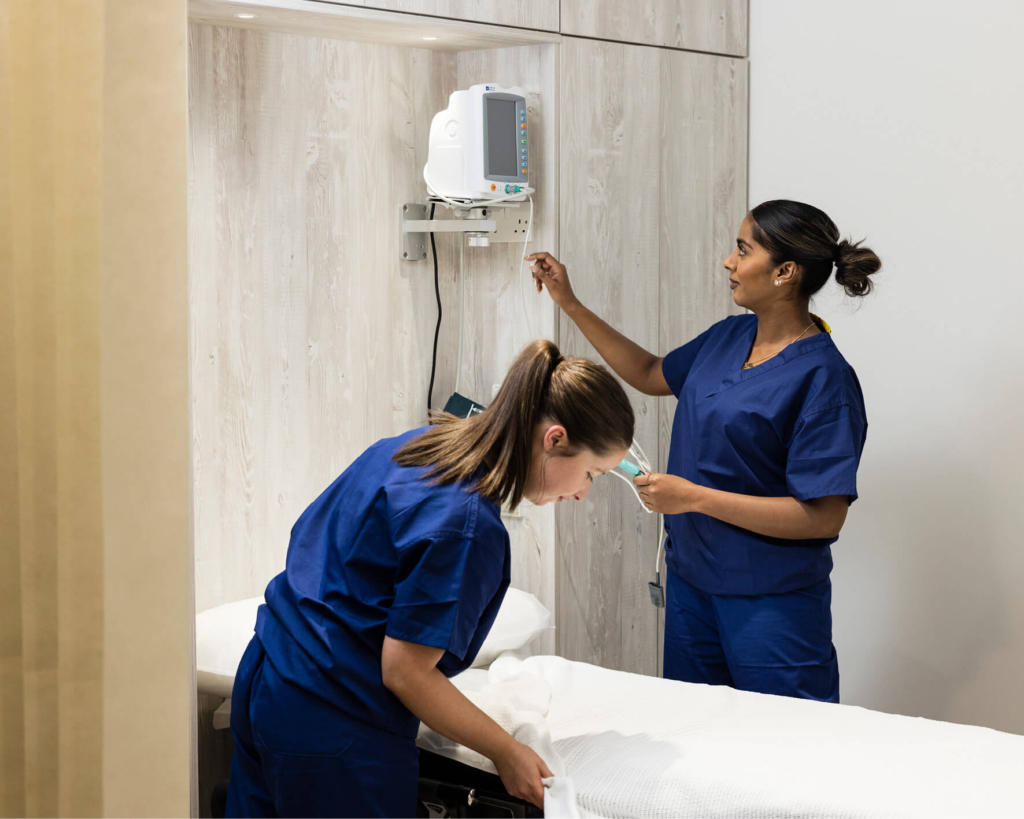 Two fertility nurses setting up a treatment room at The Evewell