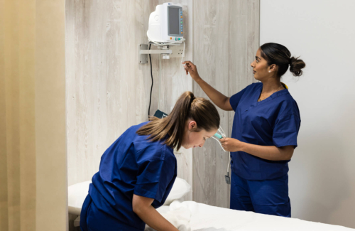 Two fertility nurses setting up a treatment room at The Evewell