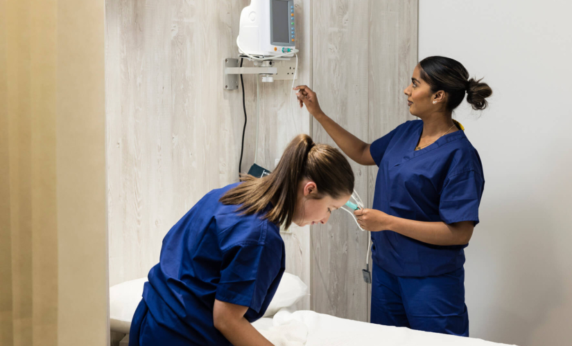 Two fertility nurses setting up a treatment room at The Evewell