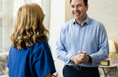 Consultant discussing male fertility with an Evewell nurse in blue srubs